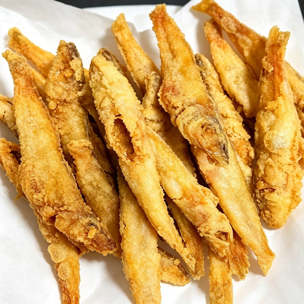 Golden deep-fried sillago fish on a platter