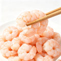 Raw peeled shrimp meat piled on a plate