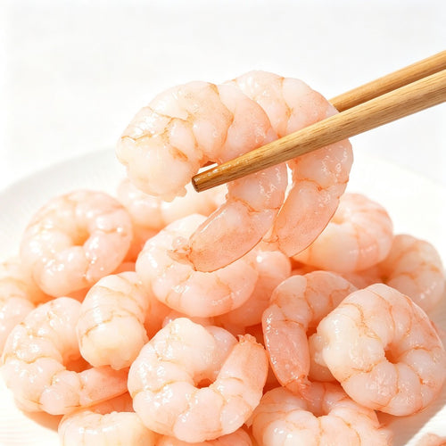 Raw peeled shrimp meat piled on a plate