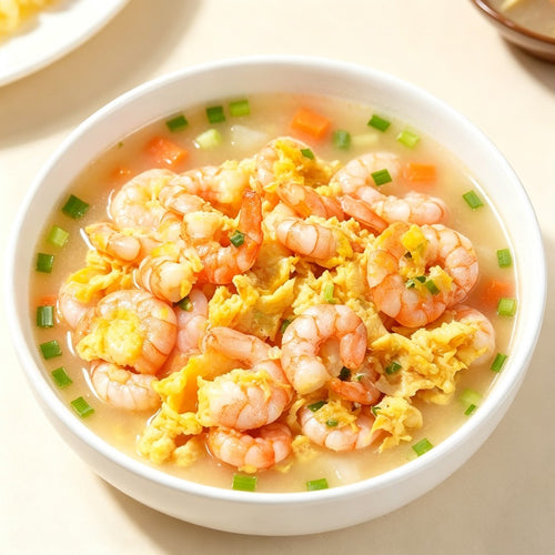 Shrimp and egg drop soup in a white bowl