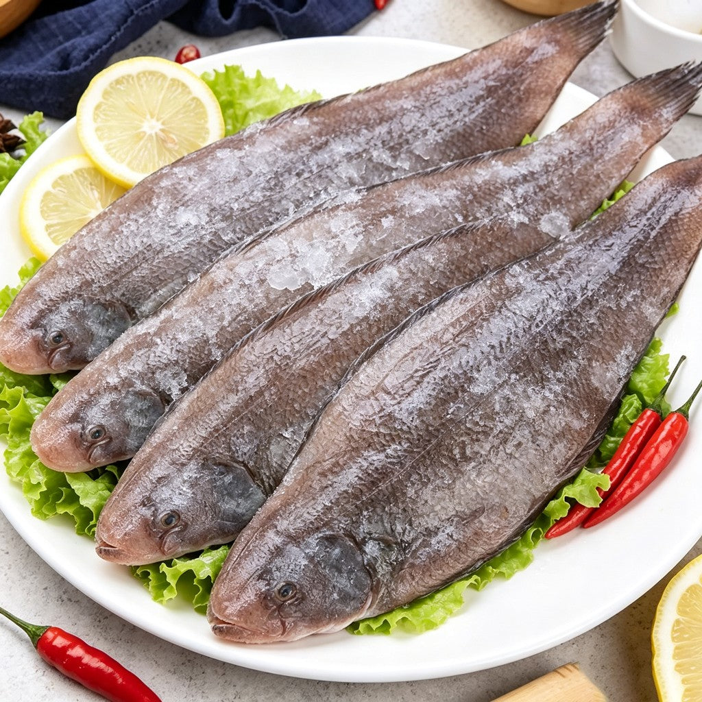 Four whole sole fish plated with lemon and chilli